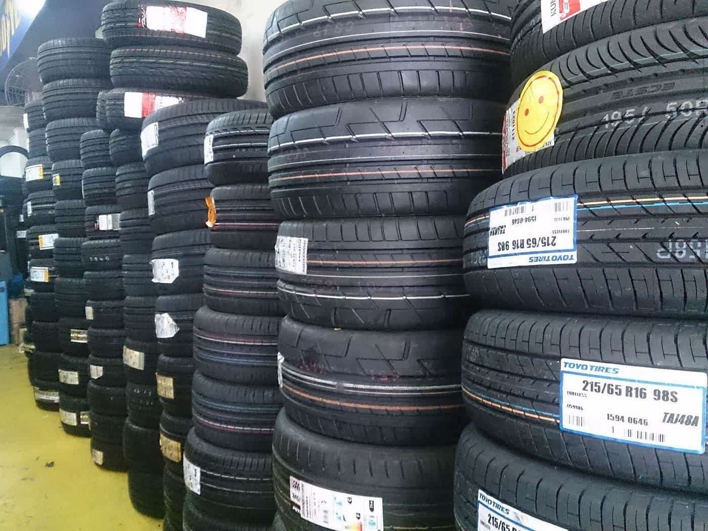 Stacks of new car tyres in a tyre shop