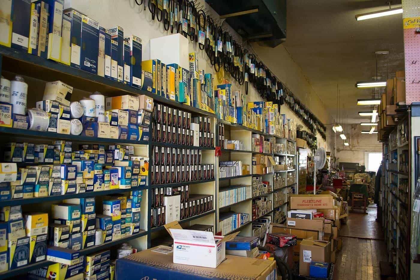 Shelves crowded with boxed parts in an auto parts store