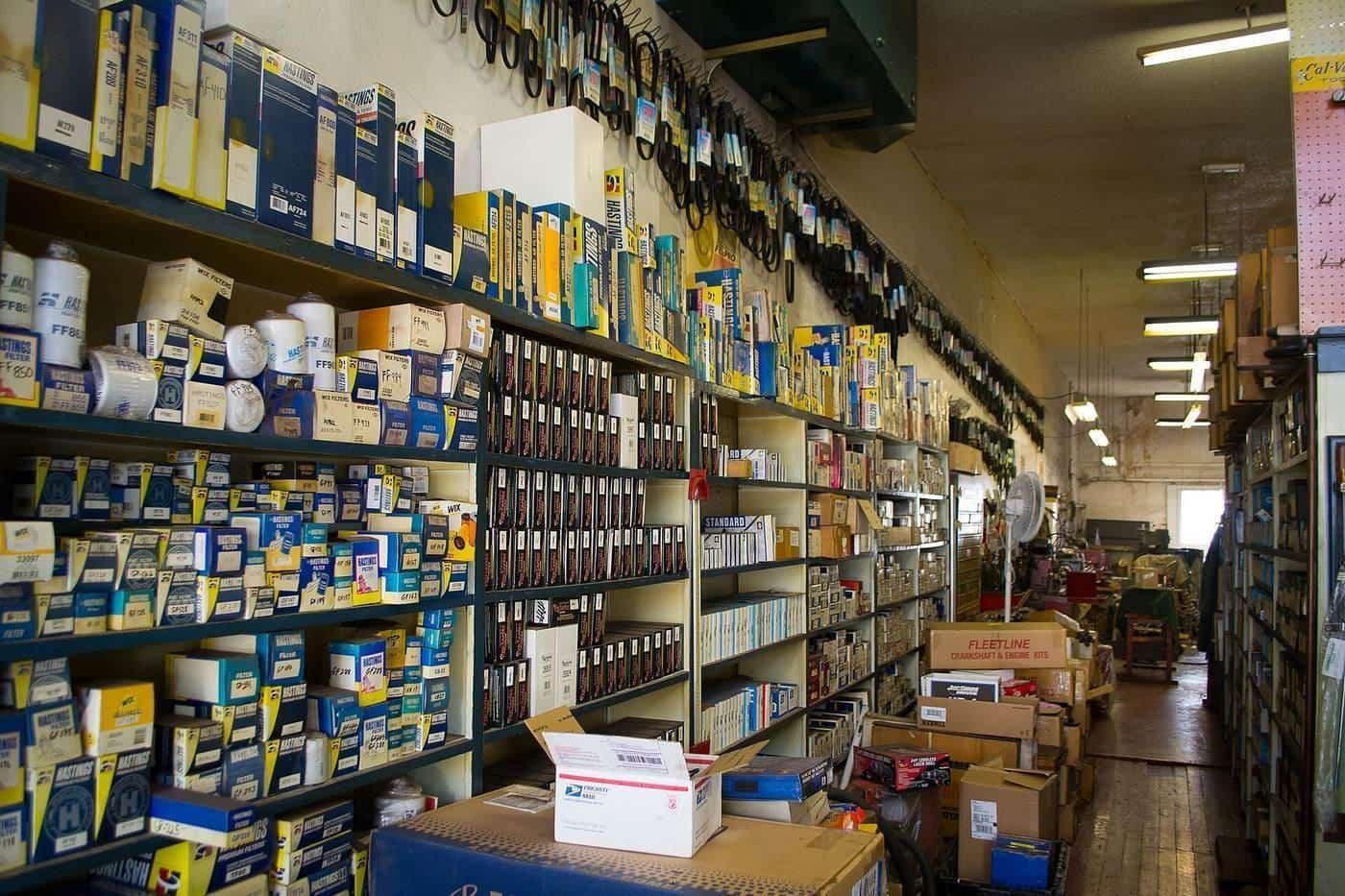 Shelves crowded with boxed parts in an auto parts store