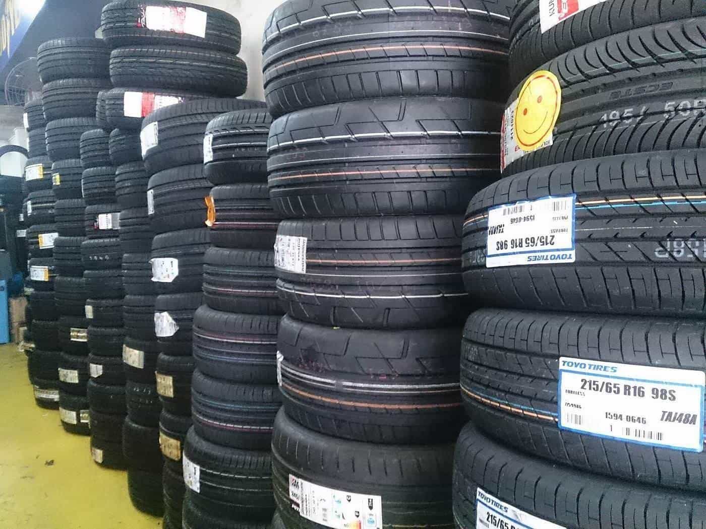Stacks of new car tyres in a tyre shop